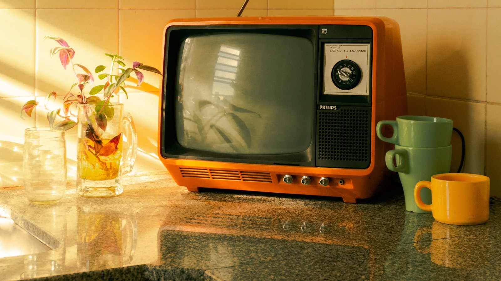Téléviseur rétro orange posé sur un plan de travail