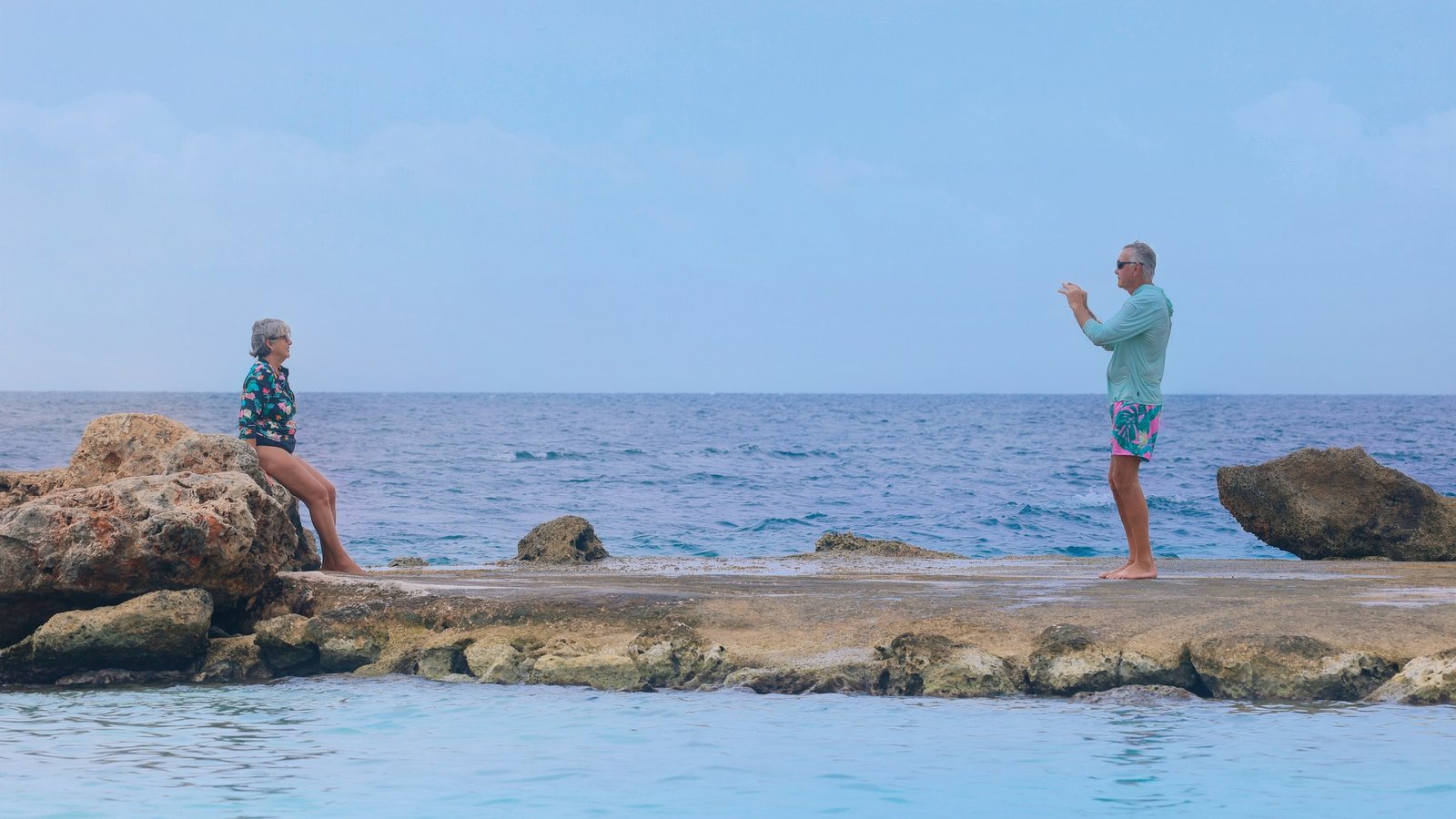 Un couple de retraités photographiant la mer