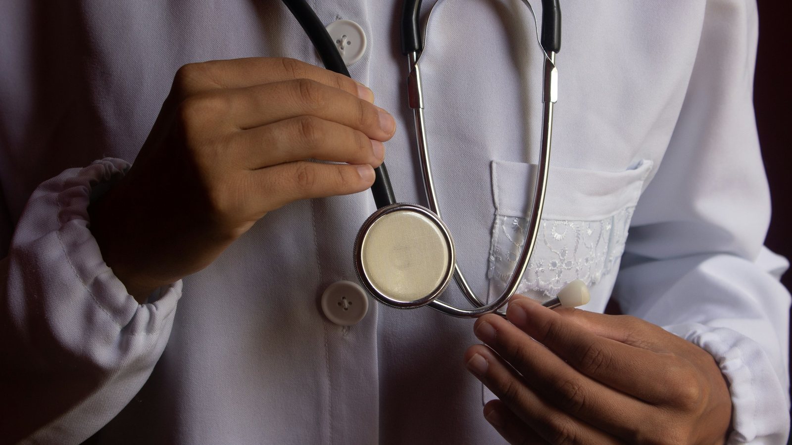Une personne en blouse blanche au stéthoscope